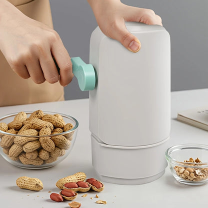 Manual Wukusy hand-crank peanut sheller machine for home and kitchen use, showing the device with its crank handle and shelling chamber.