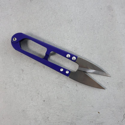 Wukusy premium sewing scissors with ergonomic handle, designed for precise cutting, shown in a home improvement setting.